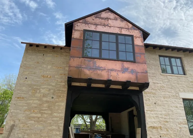Copper metal panel facade on a stone building for Roof Repair in Viera West